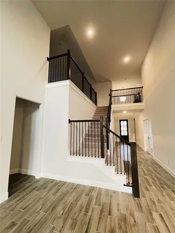 a view of entryway and hall with wooden floor