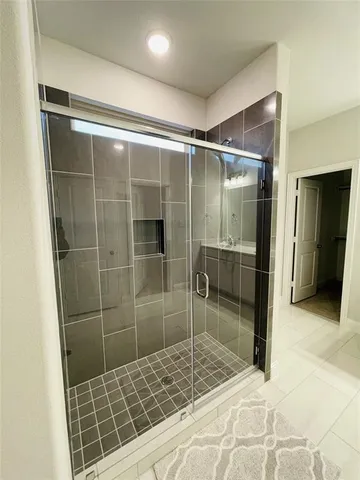 a bathroom with a shower and a sink