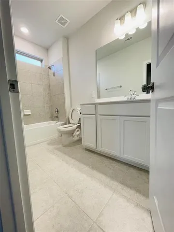 a spacious bathroom with a double vanity sink toilet mirror and shower
