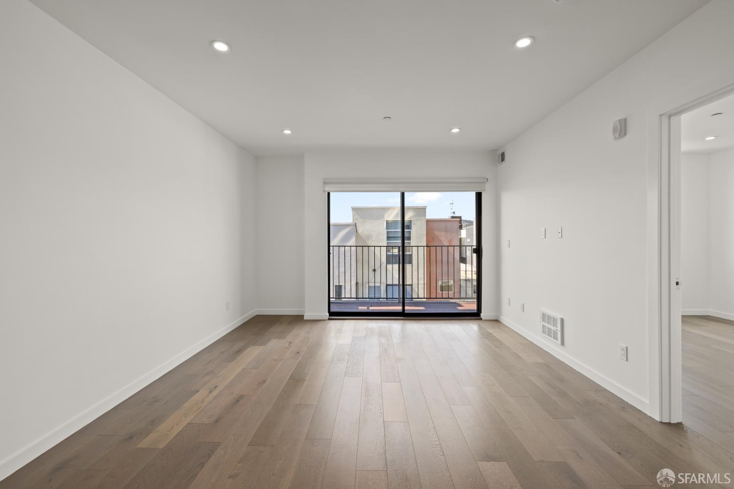 252 9th Street, Unit 503 San Francisco, CA 94103 - Photo 8 of 15 wooden floor in an empty room with a window