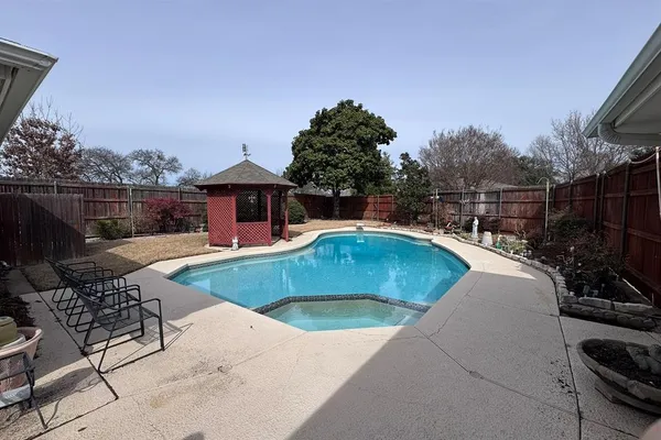 a view of a swimming pool with a patio