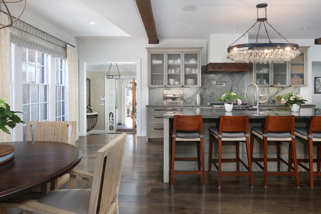 39 Worthington Road Brookline, MA 02446 - Photo 12 of 40 a dining room with furniture a chandelier and wooden floor
