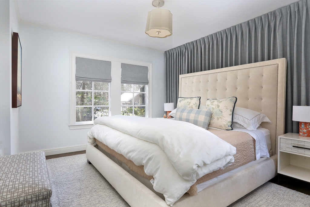 39 Worthington Road Brookline, MA 02446 - Photo 15 of 40 a large bed sitting in a bedroom next to a window