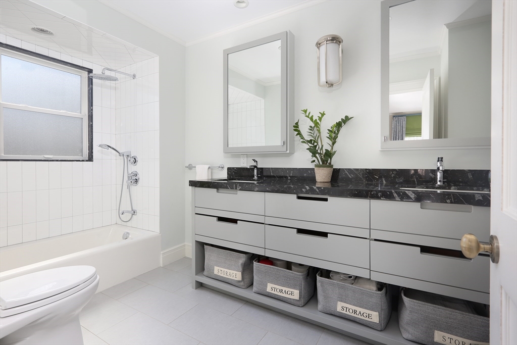 39 Worthington Road Brookline, MA 02446 - Photo 26 of 40 a bathroom with a double vanity sink a toilet and a mirror