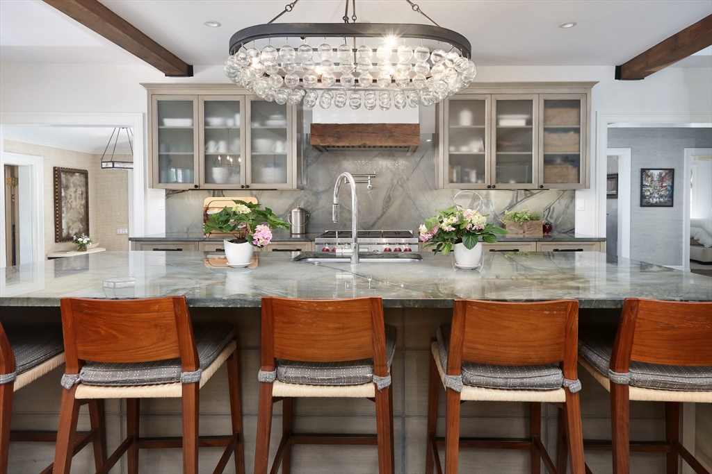 39 Worthington Road Brookline, MA 02446 - Photo 8 of 40 a dining room with granite countertop a table and chairs in it