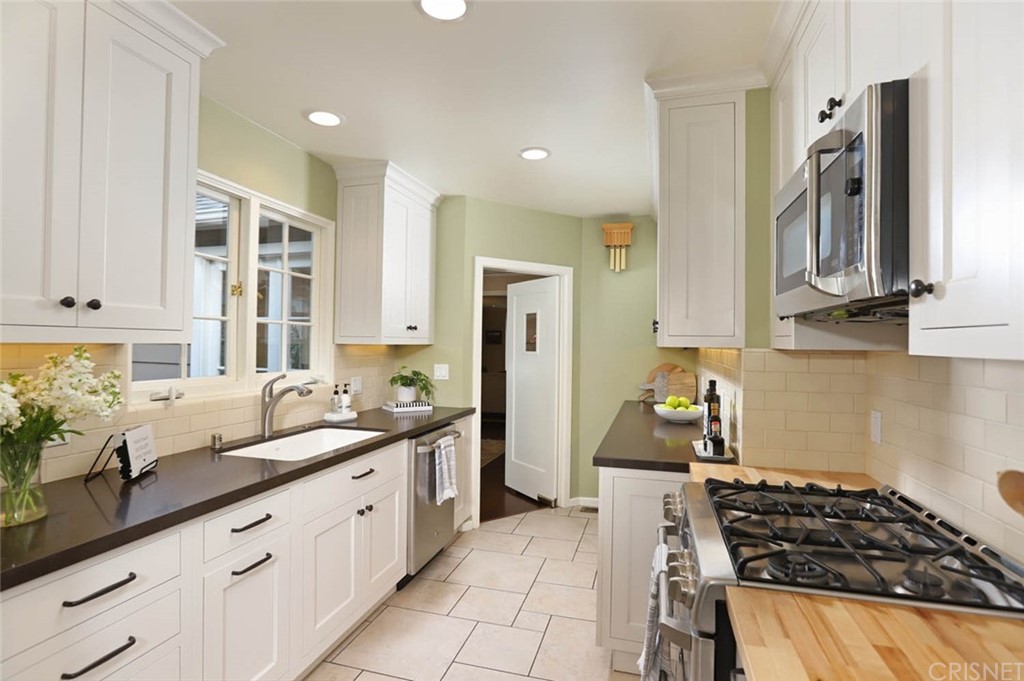 206 Sierra View Road Pasadena, CA 91105 - Photo 22 of 46 a kitchen with stainless steel appliances a stove a sink and a refrigerator