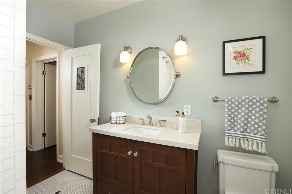 206 Sierra View Road Pasadena, CA 91105 - Photo 30 of 46 a bathroom with a toilet a sink and mirror