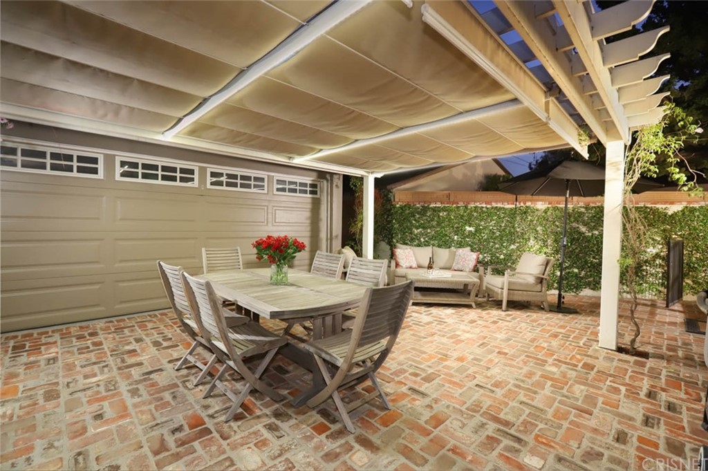 206 Sierra View Road Pasadena, CA 91105 - Photo 39 of 46 a patio with a table and chairs and potted plants
