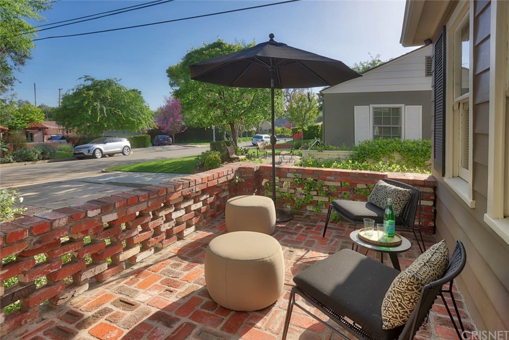 206 Sierra View Road Pasadena, CA 91105 - Photo 10 of 46 a patio with a table and chairs under an umbrella
