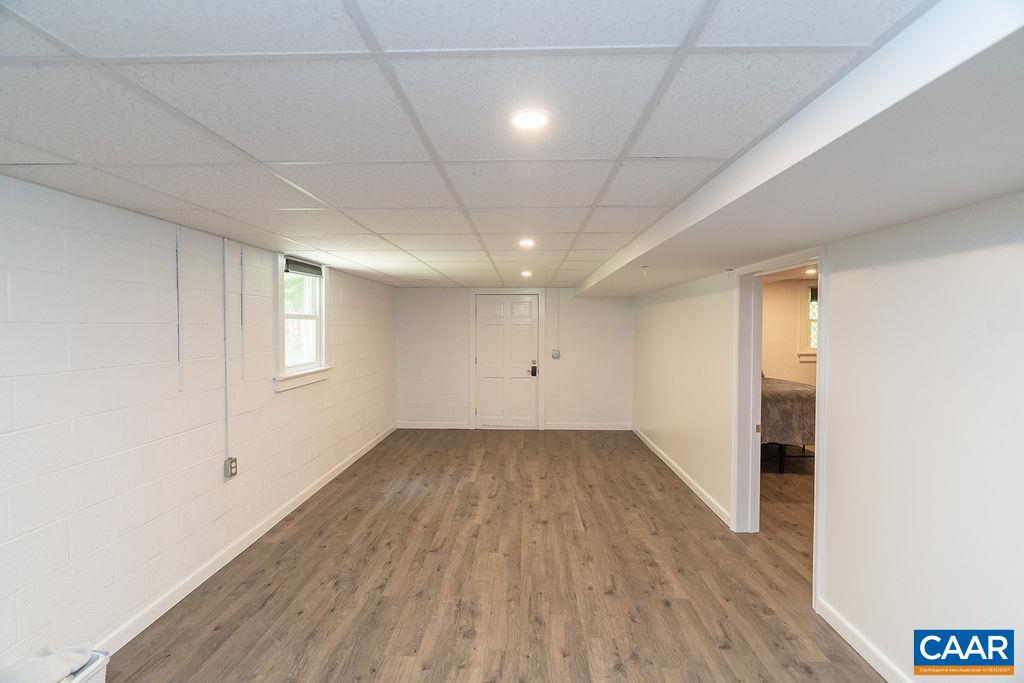 6920 Albevanna Spring Road Scottsville, VA 24590 - Photo 30 of 47 an empty room with wooden floor and windows