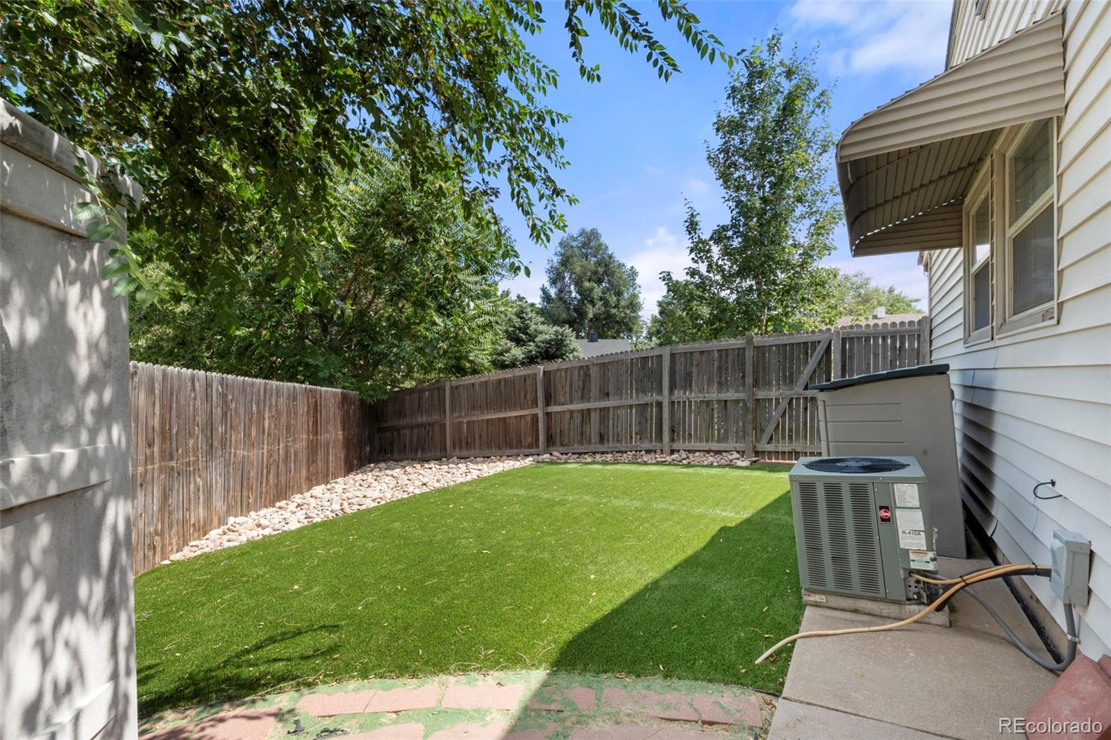 1845 South Mabry Way Denver, CO 80219 - Photo 16 of 20 a view of a backyard with a small cabin and a chair