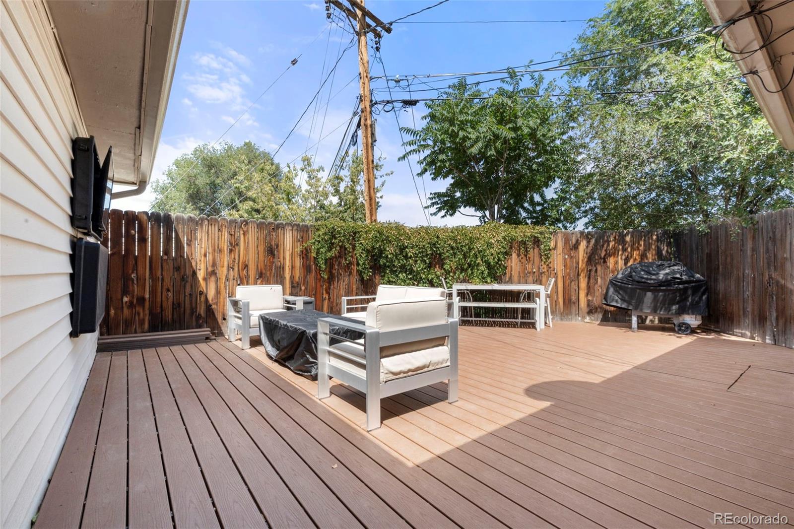 1845 South Mabry Way Denver, CO 80219 - Photo 17 of 20 a view of backyard with a deck and wooden floor