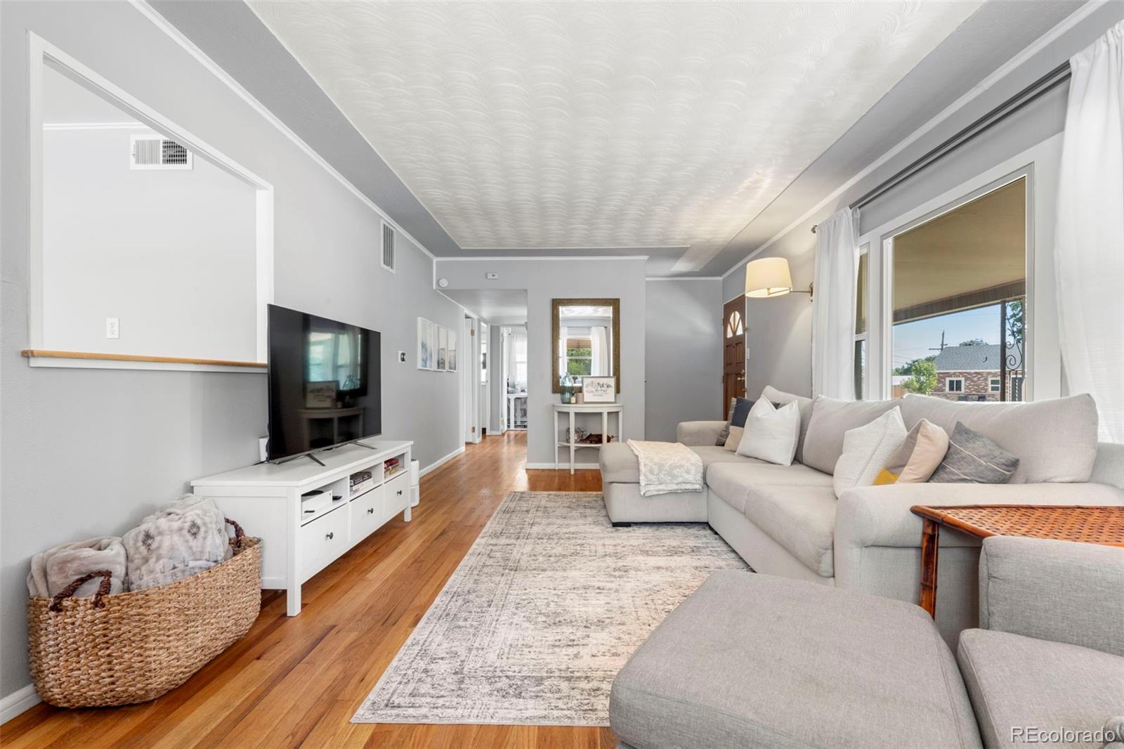 1845 South Mabry Way Denver, CO 80219 - Photo 5 of 20 a living room with furniture and a flat screen tv