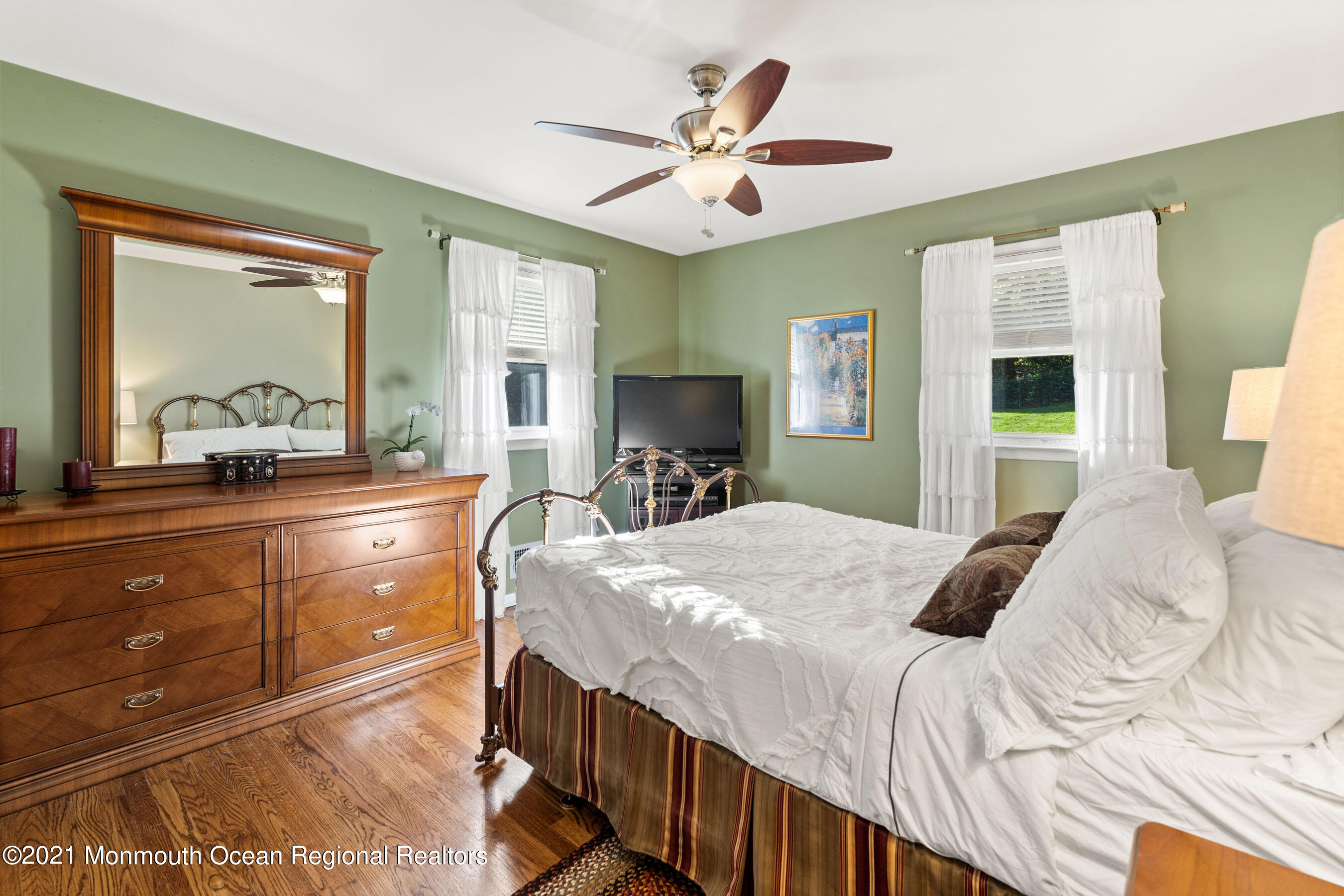 105 Bruce Road Red Bank, NJ 07701 - Photo 12 of 26 a bedroom with a bed and a large mirror on the dresser