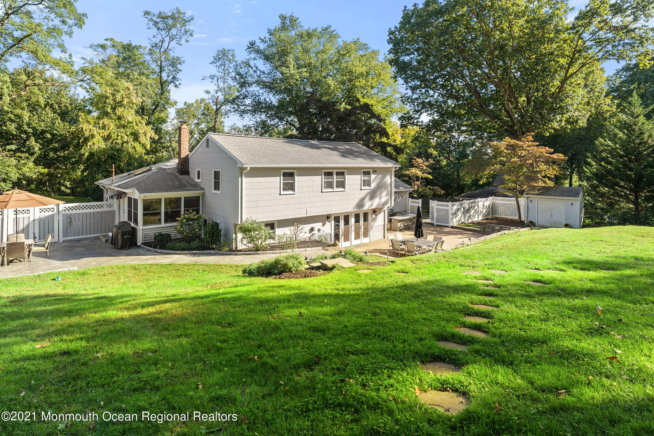 105 Bruce Road Red Bank, NJ 07701 - Photo 24 of 26 a view of a house with a big yard and large trees