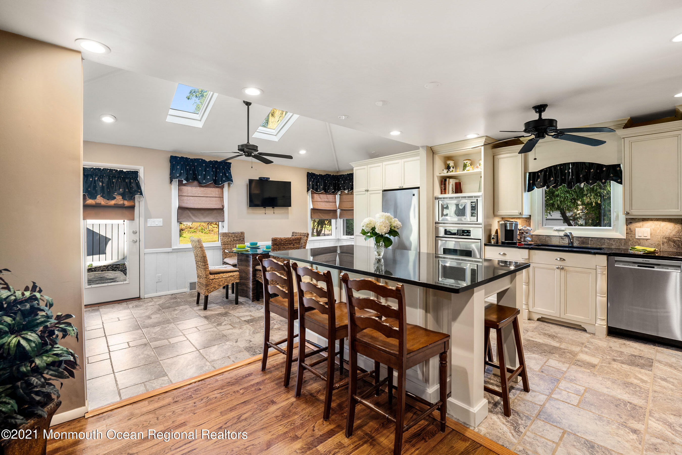 105 Bruce Road Red Bank, NJ 07701 - Photo 6 of 26 a dining area with stainless steel appliances kitchen island granite countertop a dining table chairs and granite counter tops