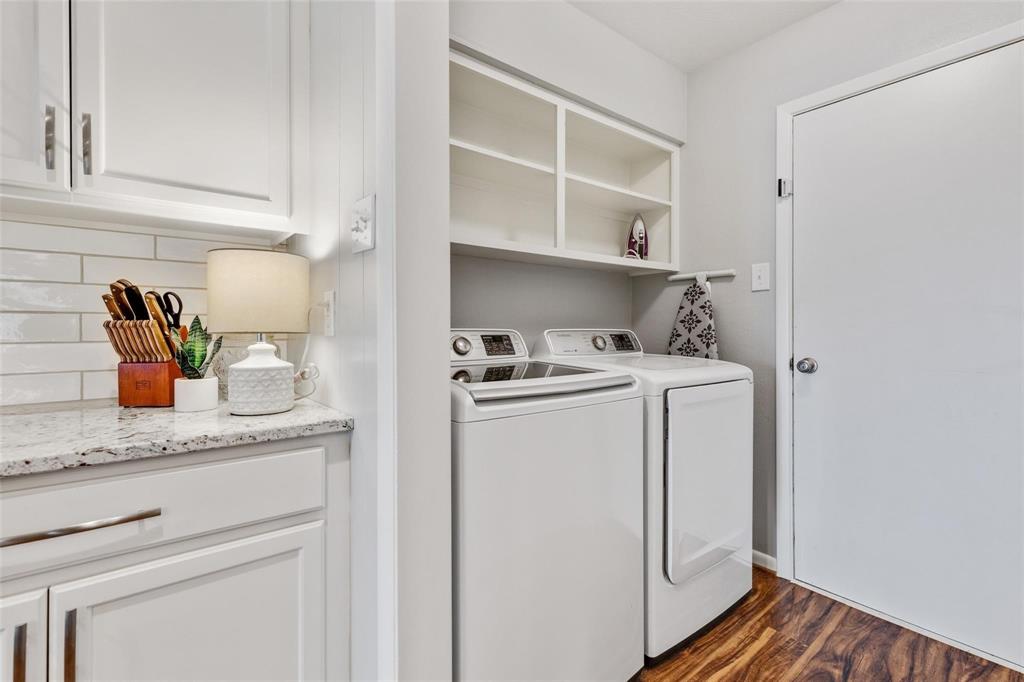 607 West Cedar Street Celina, TX 75009 - Photo 12 of 26 a utility room with cabinets washer and dryer