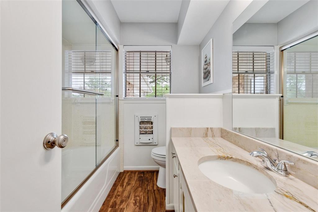 607 West Cedar Street Celina, TX 75009 - Photo 20 of 26 a bathroom with a granite countertop sink and a mirror