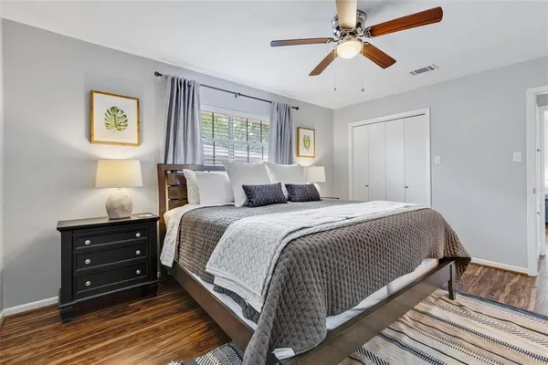 a bedroom with a bed and a chandelier fan