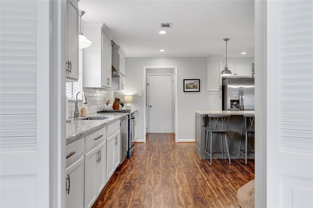 607 West Cedar Street Celina, TX 75009 - Photo 26 of 26 a kitchen with kitchen island granite countertop a sink stove and cabinets