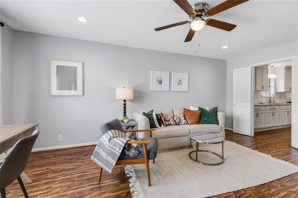 a living room with furniture and a wooden floor