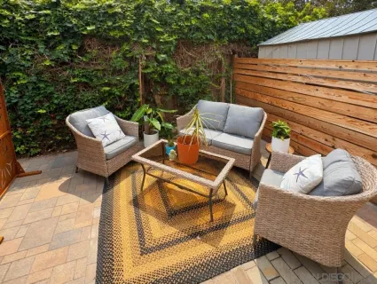 a view of a porch with a table and chairs