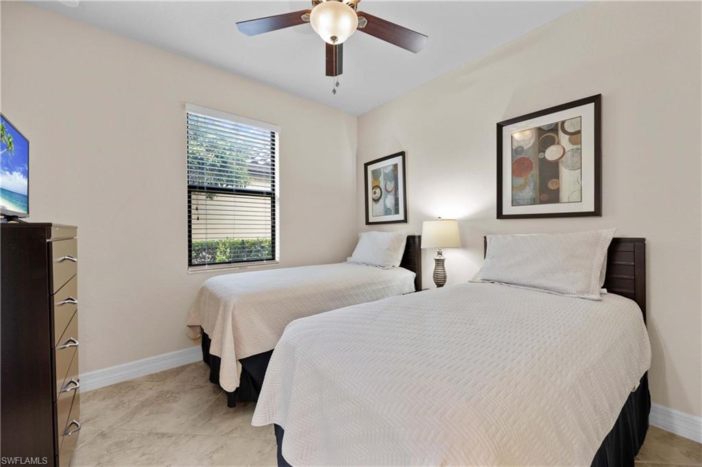 9254 Veneto Place Naples, FL 34113 - Photo 13 of 30 Bedroom with ceiling fan and light tile floors