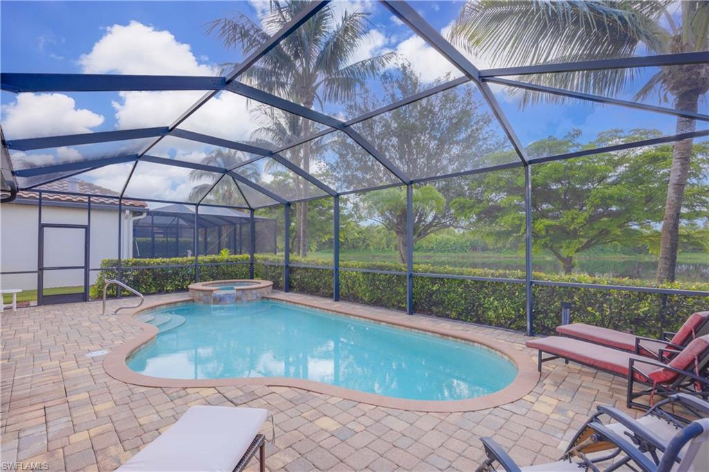 9254 Veneto Place Naples, FL 34113 - Photo 20 of 30 View of swimming pool featuring a patio, glass enclosure, and an in ground hot tub