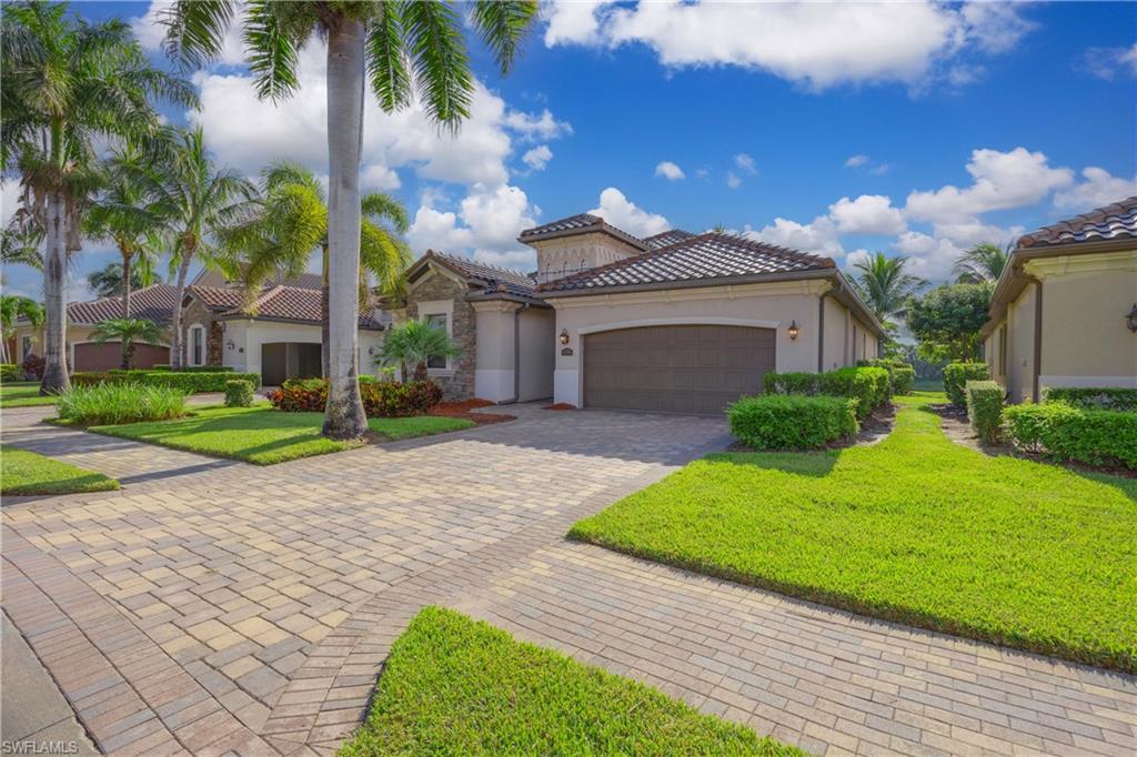 9254 Veneto Place Naples, FL 34113 - Photo 2 of 30 Mediterranean / spanish-style house with a garage and a front yard