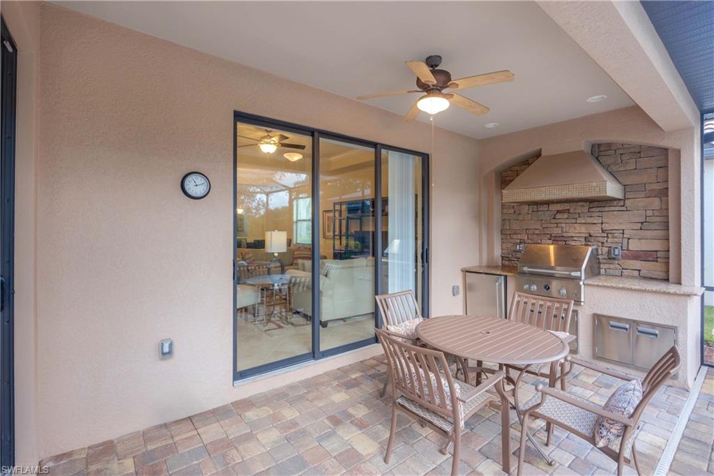 9254 Veneto Place Naples, FL 34113 - Photo 21 of 30 View of terrace with an outdoor kitchen, ceiling fan, and grilling area