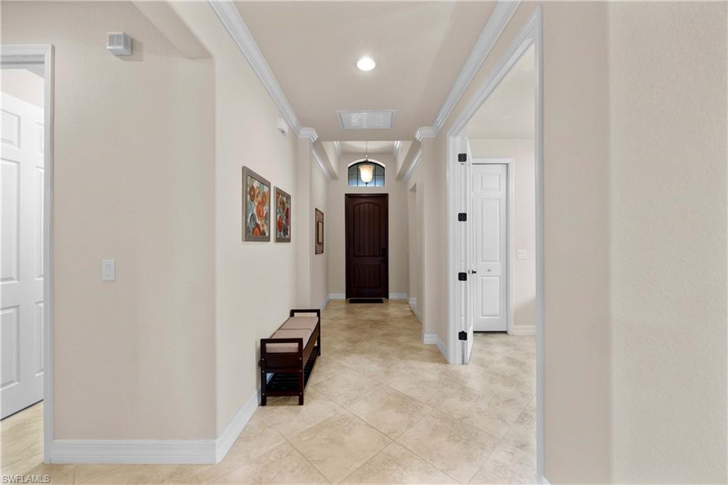 9254 Veneto Place Naples, FL 34113 - Photo 4 of 30 Hallway with ornamental molding and light tile floors
