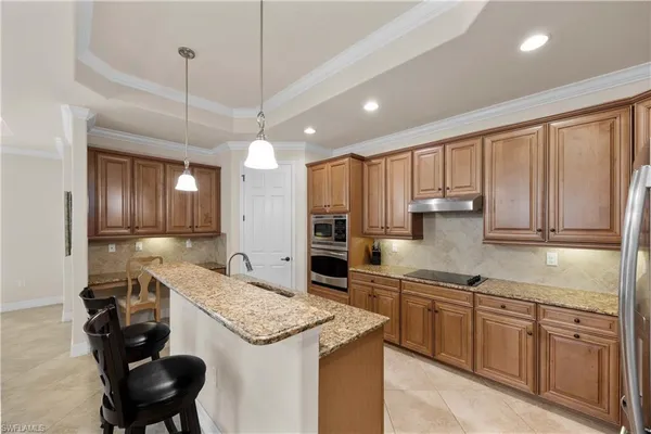 a kitchen with a sink refrigerator and cabinets
