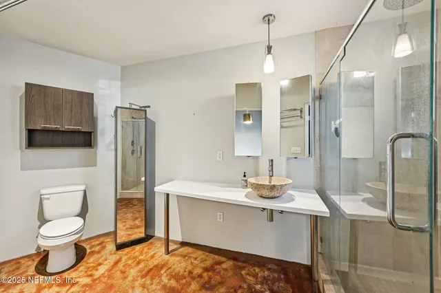 a bathroom with a sink toilet and shower
