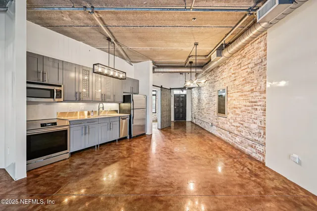 a large kitchen with cabinets and stainless steel appliances