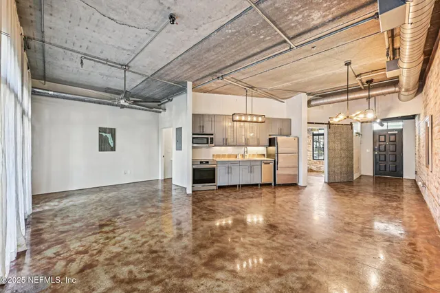 a view of a room with a sink and cabinets