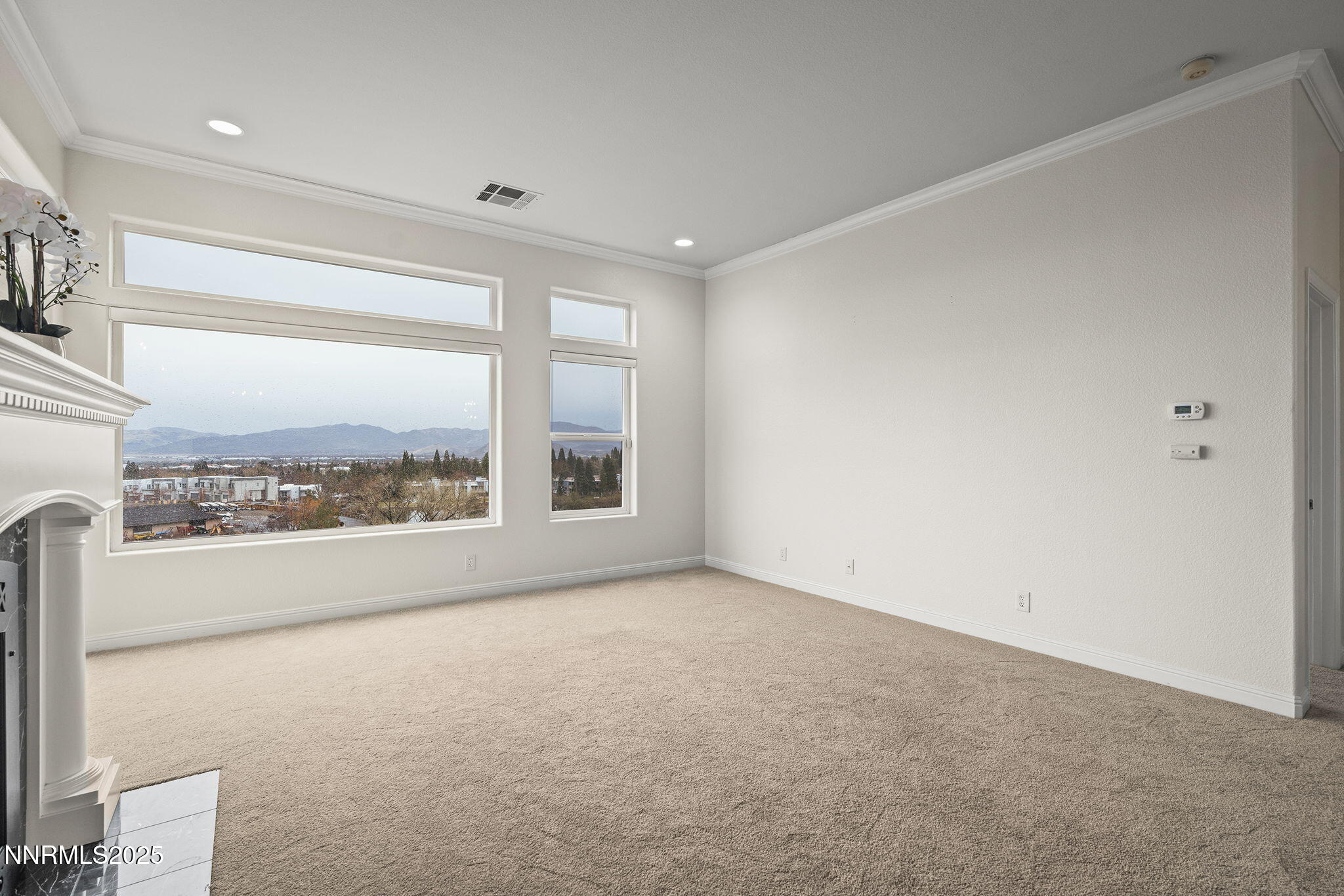 2636 Edgerock Road Reno, NV 89519 - Photo 13 of 54 a view of a big room with windows and chandelier fan