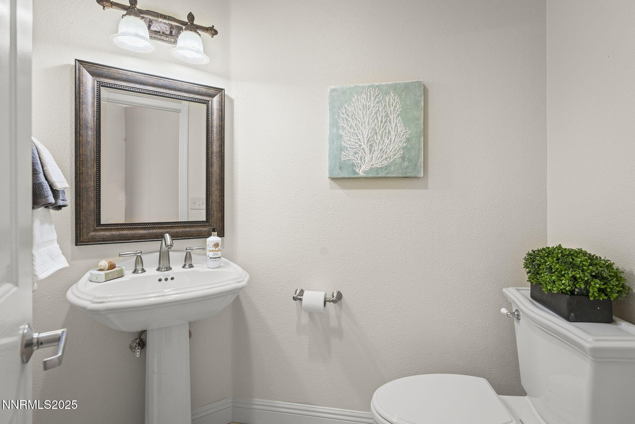 2636 Edgerock Road Reno, NV 89519 - Photo 20 of 54 a bathroom with a toilet sink and mirror