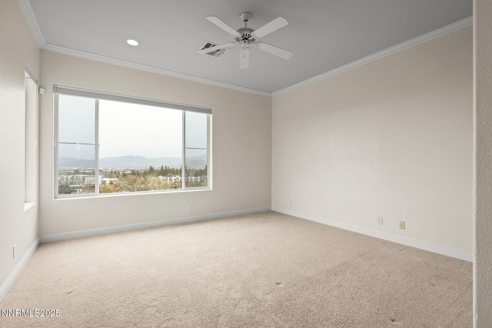 2636 Edgerock Road Reno, NV 89519 - Photo 21 of 54 an empty room with a window and a ceiling fan