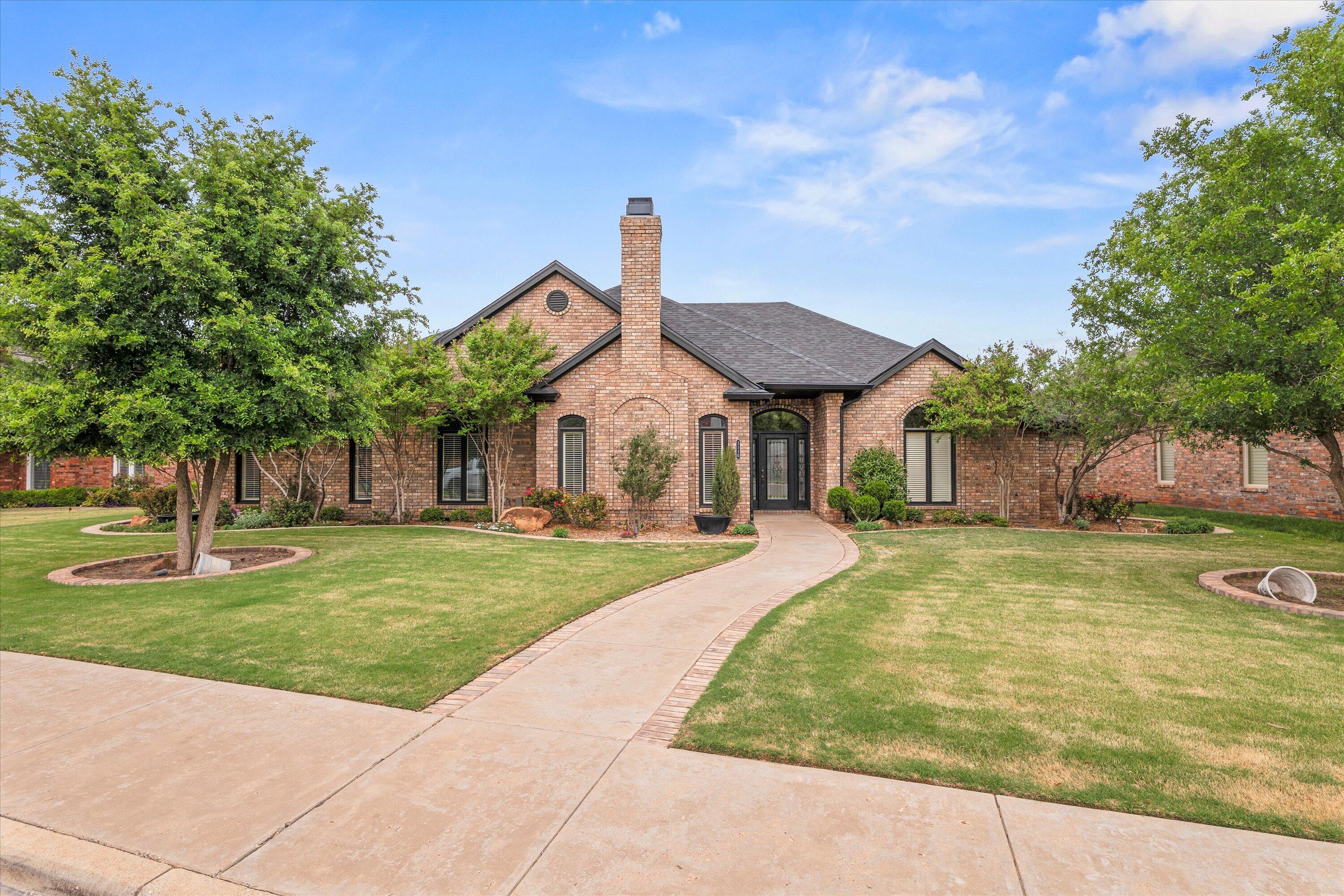 5110 96th Street Lubbock, TX 79424 - Photo 1 of 50 a front view of a house with garden