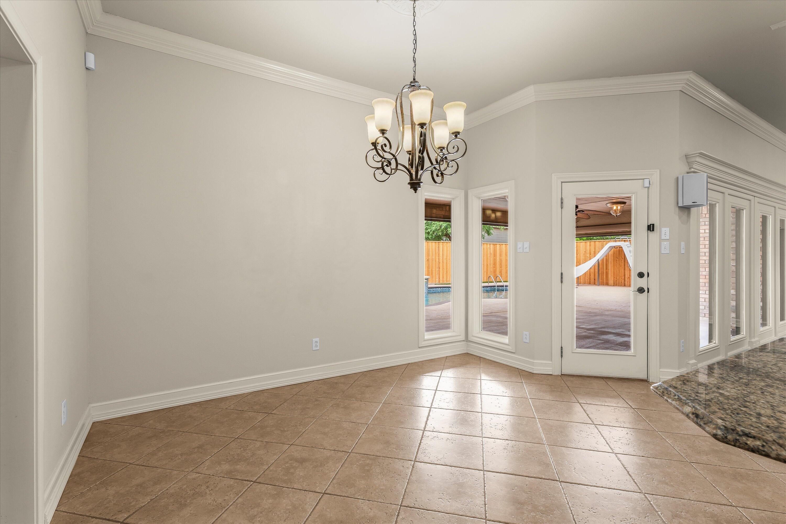 5110 96th Street Lubbock, TX 79424 - Photo 14 of 50 a view of a livingroom with a chandelier & cabinets