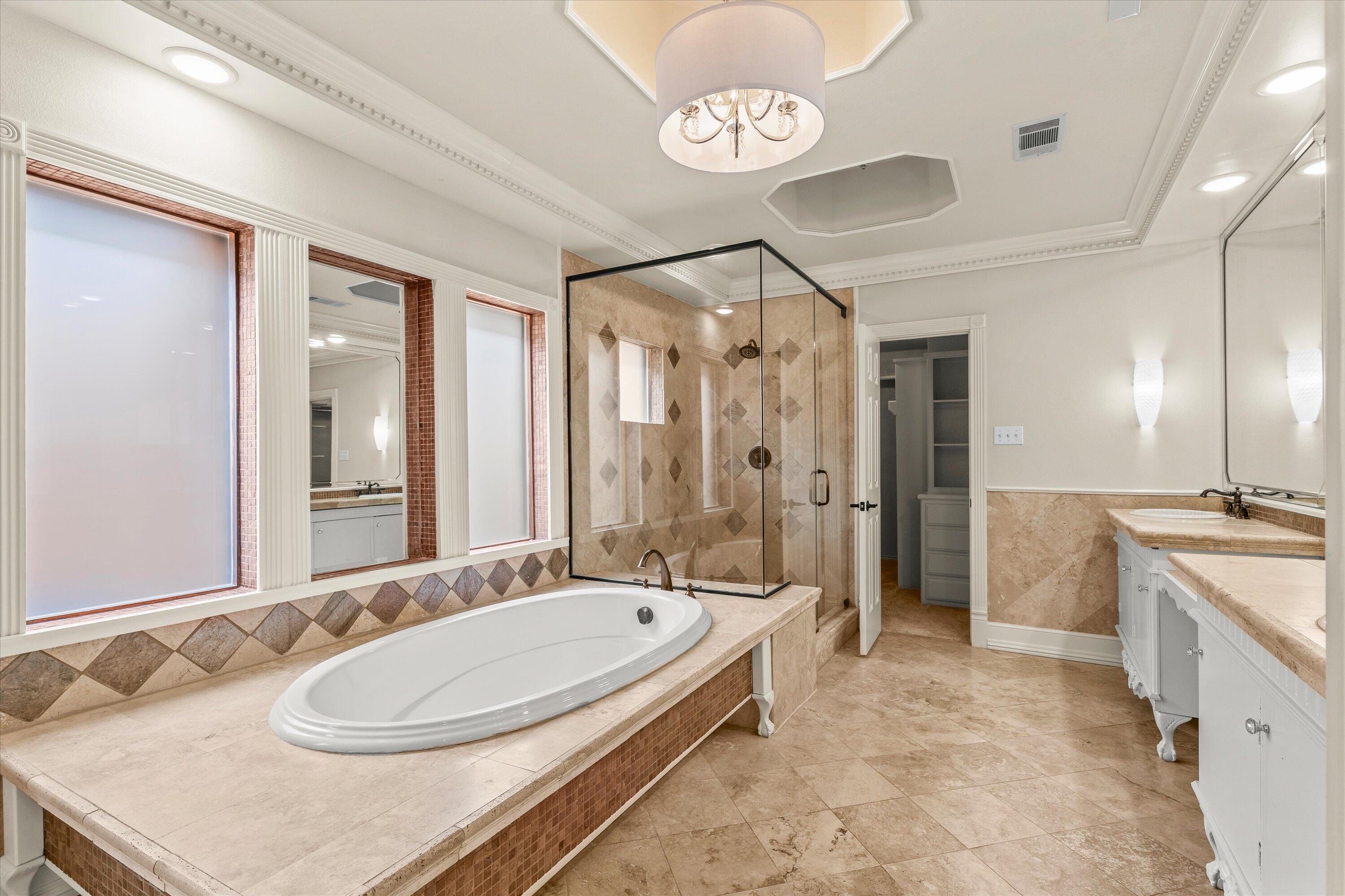 5110 96th Street Lubbock, TX 79424 - Photo 22 of 50 a bathroom with a sink a large mirror and a shower
