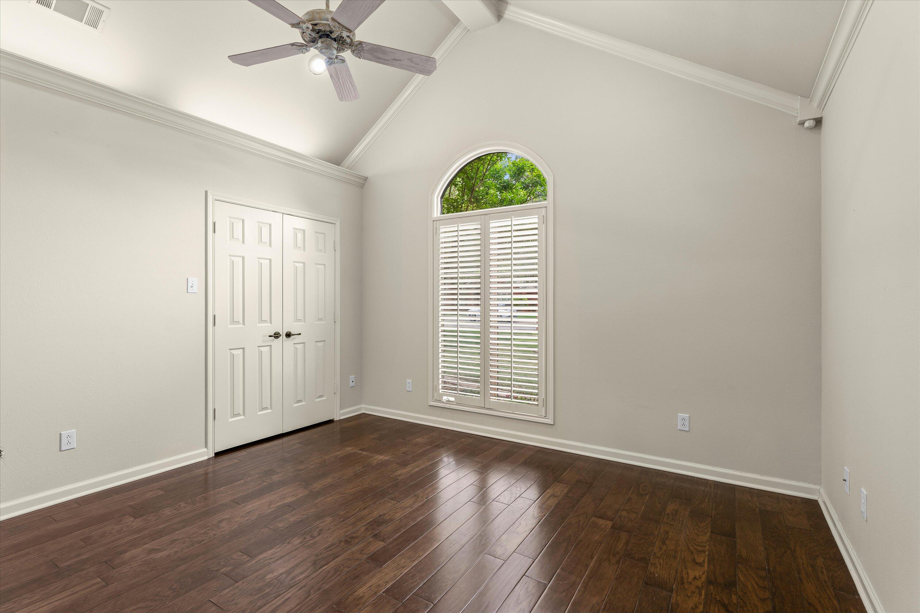 5110 96th Street Lubbock, TX 79424 - Photo 28 of 50 an empty room with wooden floor chandelier fan and windows