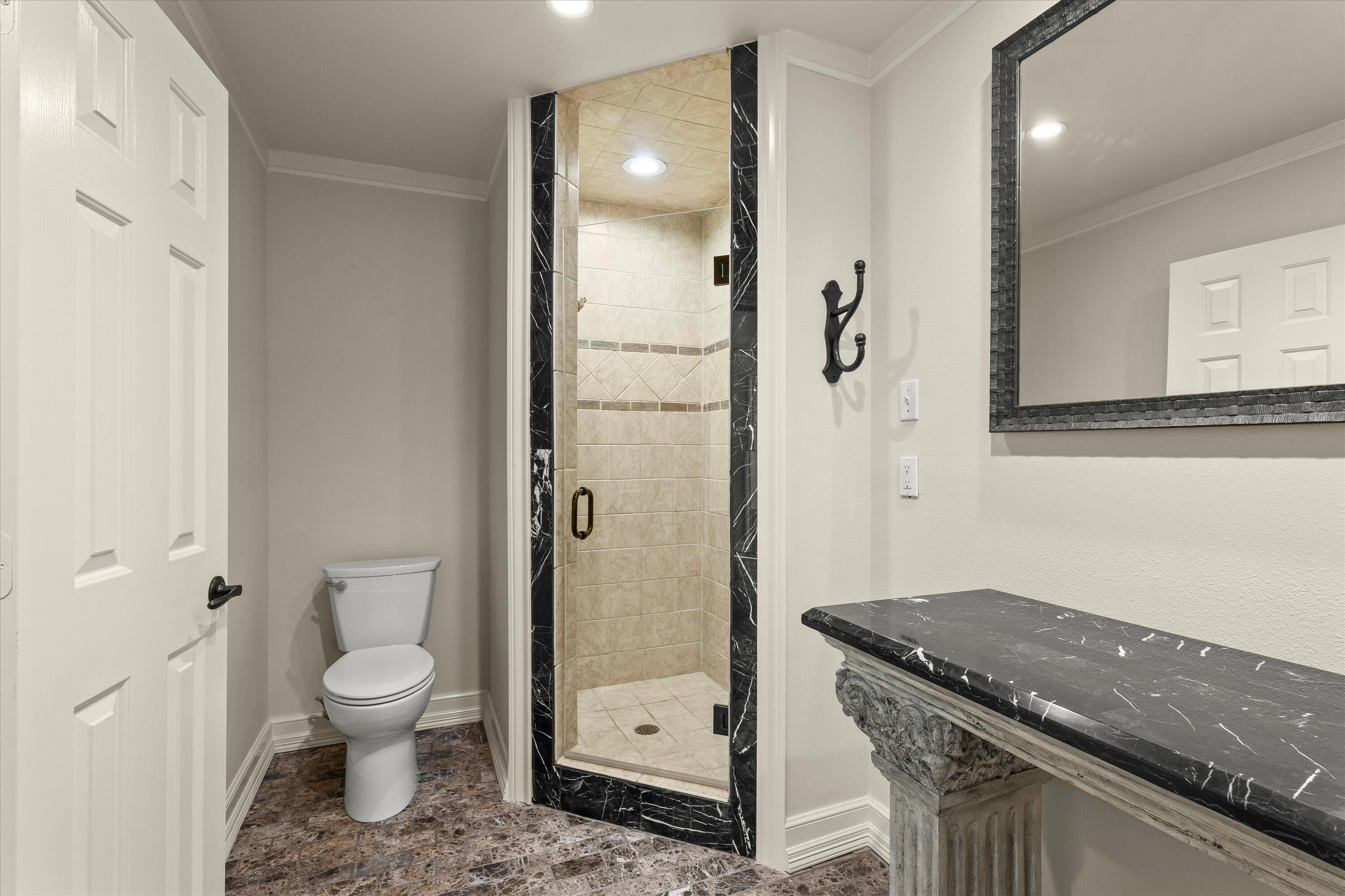 5110 96th Street Lubbock, TX 79424 - Photo 30 of 50 a bathroom with a granite countertop sink a toilet and shower