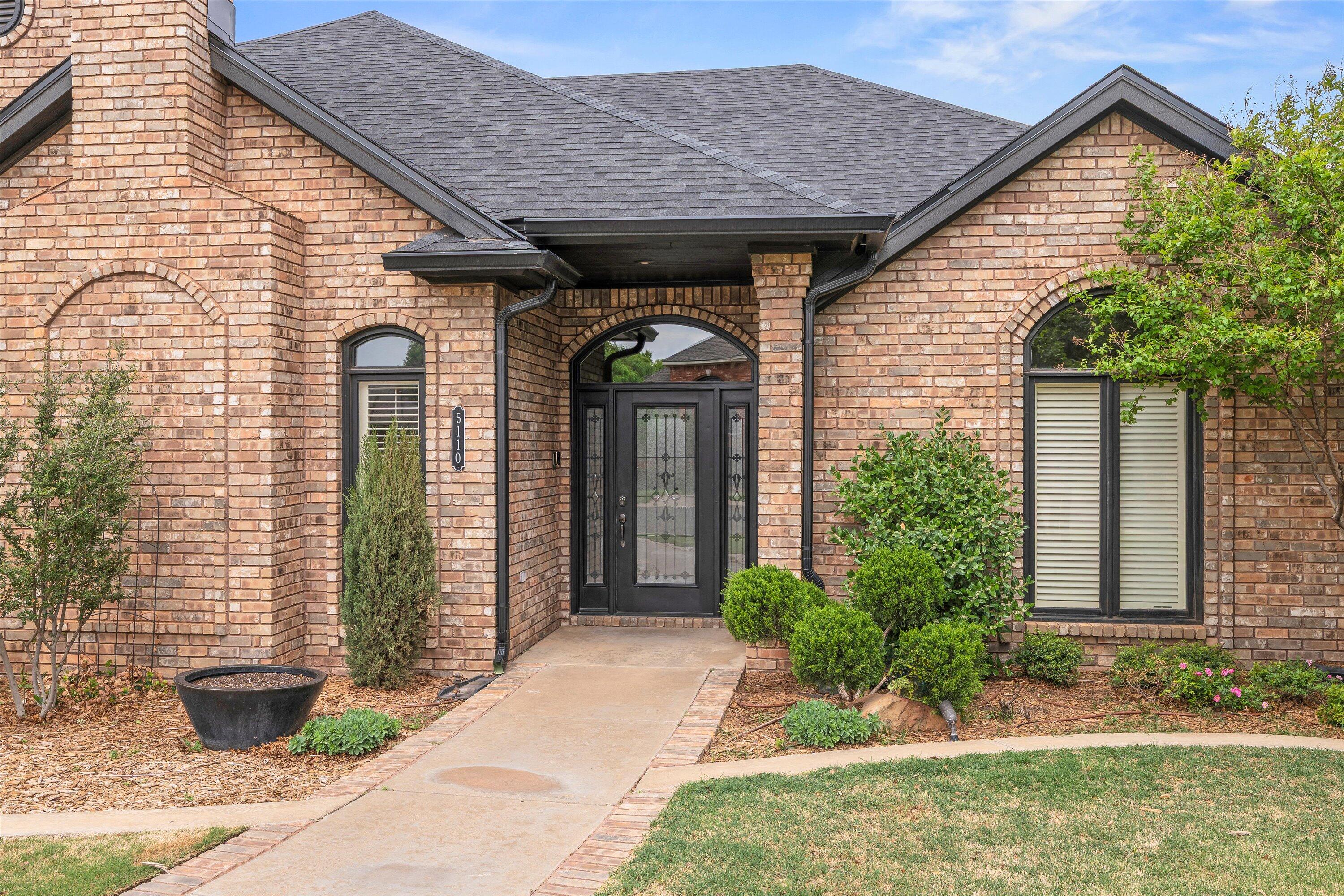 5110 96th Street Lubbock, TX 79424 - Photo 3 of 50 a front view of a house with garden