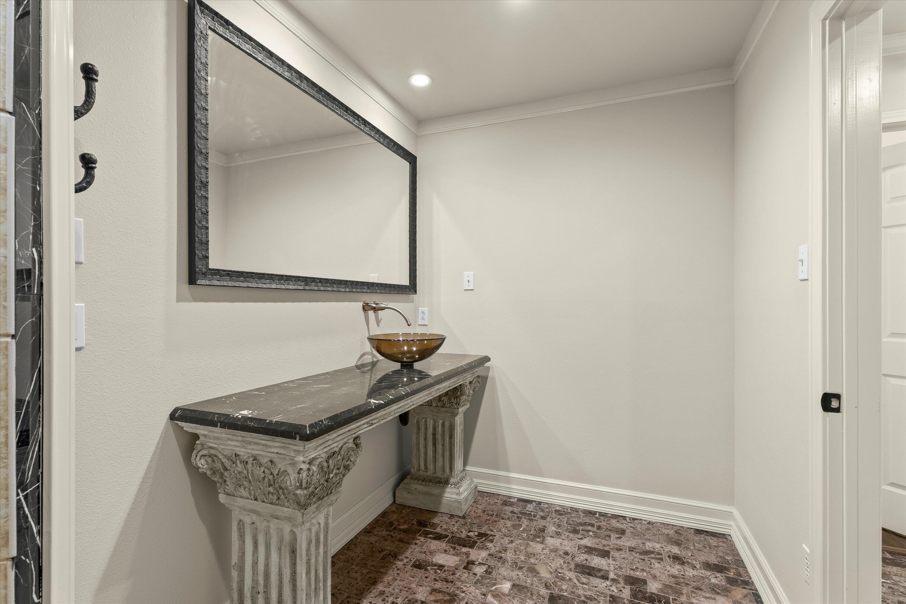 5110 96th Street Lubbock, TX 79424 - Photo 31 of 50 a bathroom with a granite countertop sink and a mirror