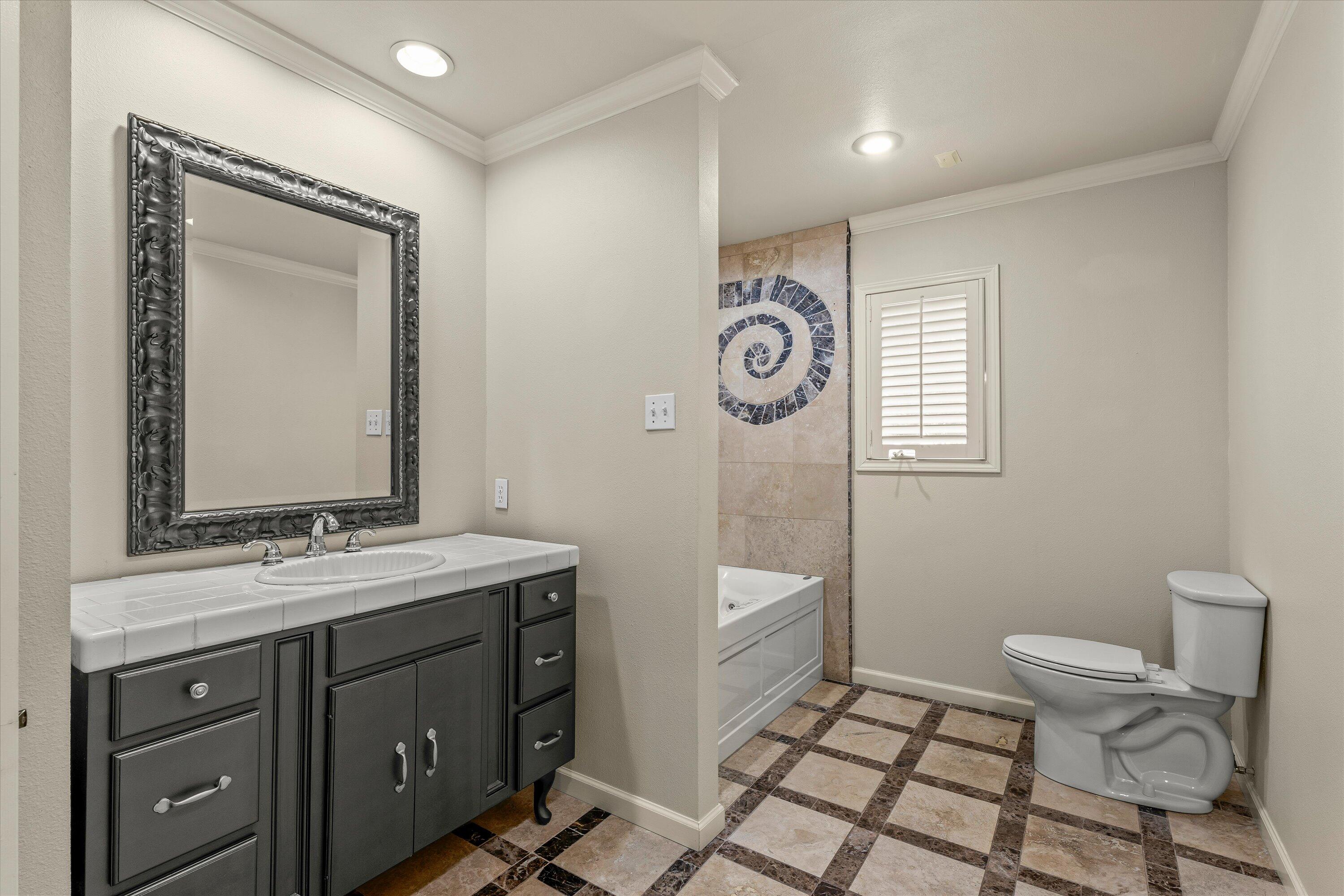 5110 96th Street Lubbock, TX 79424 - Photo 34 of 50 a bathroom with a sink a toilet and mirror