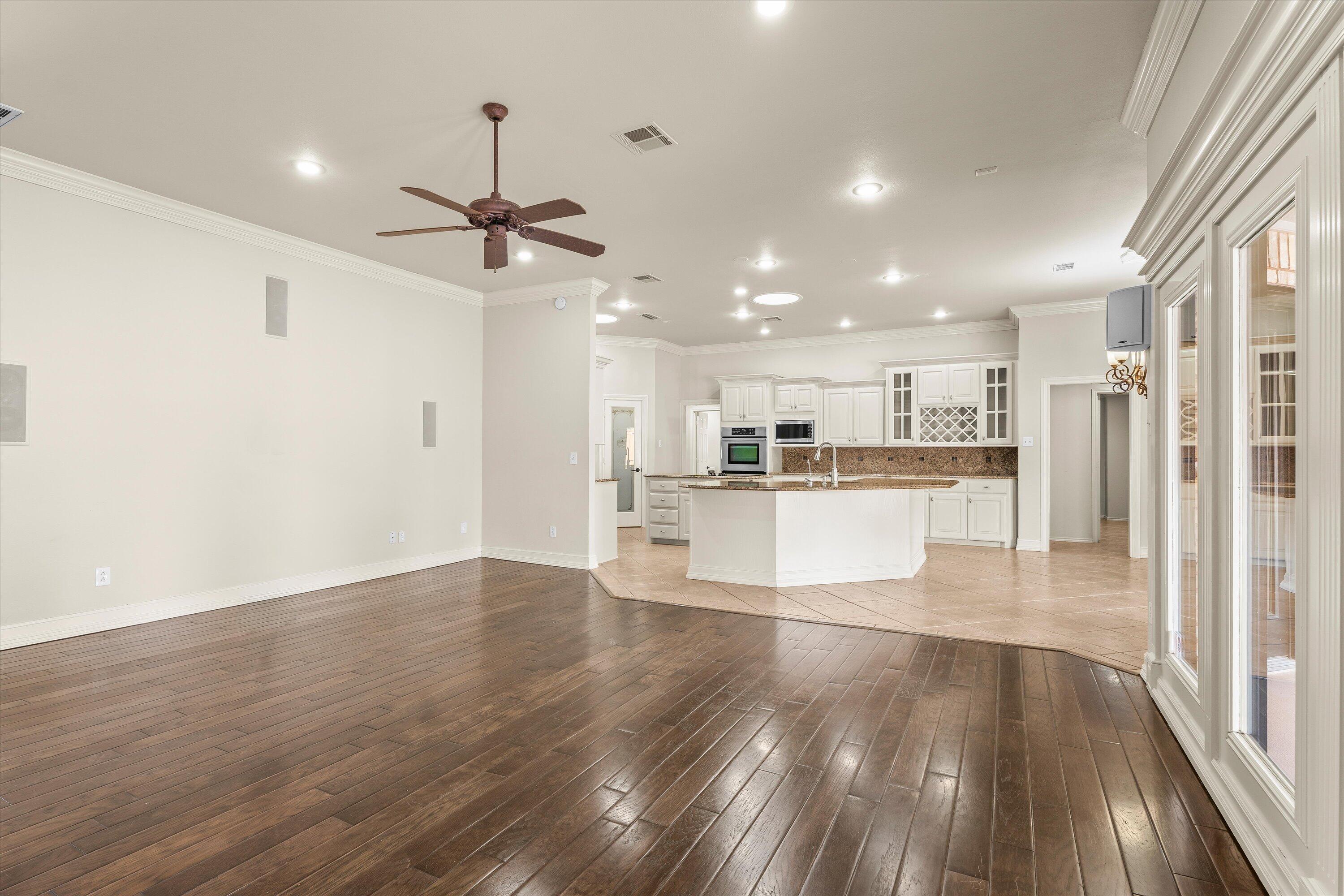 5110 96th Street Lubbock, TX 79424 - Photo 9 of 50 a view of a kitchen with wooden floor and a kitchen