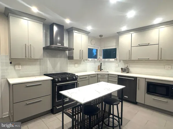a kitchen with a stove a sink and a refrigerator