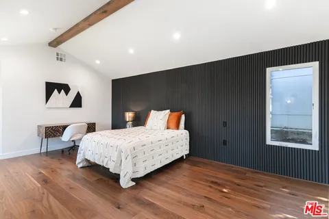 a bedroom with a bed and a night stand