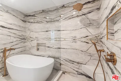 a white bath tub sitting in a bathroom